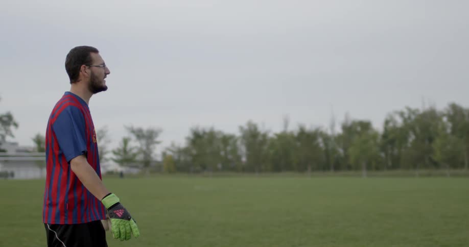 A soccer player walks on a soccer field