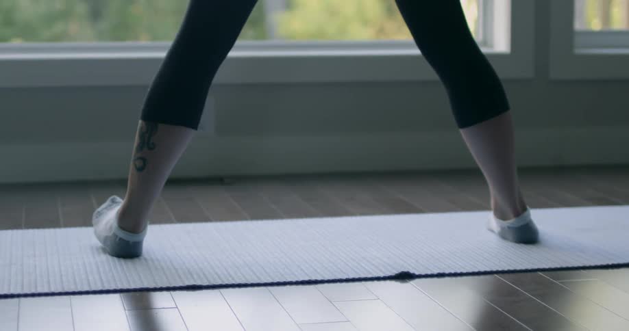 A woman does yoga on a yoga mat