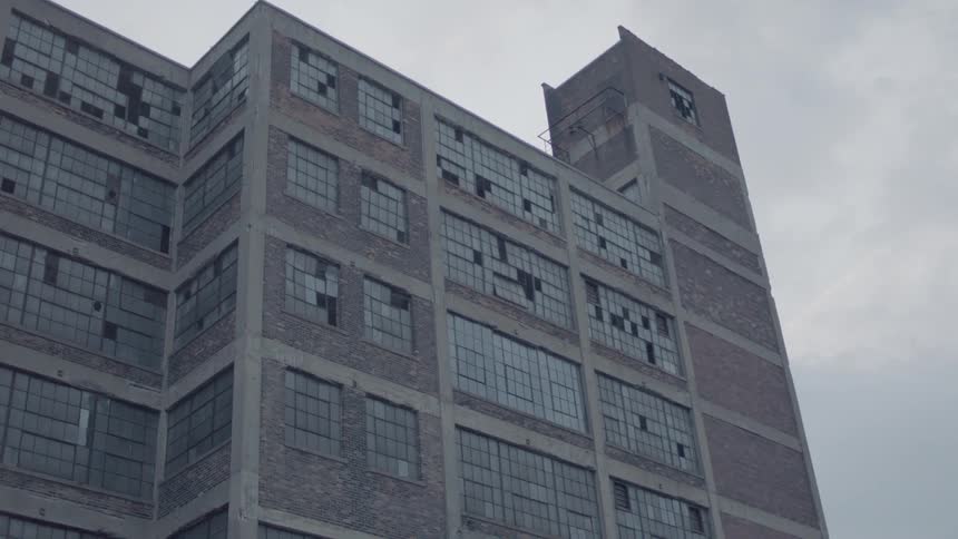 A desolate building with many broken windows