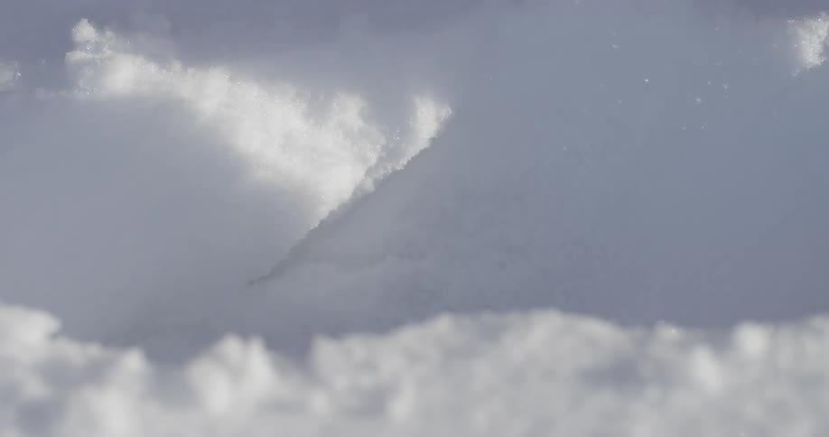A small plastic shovel is used to move snow