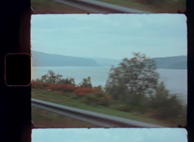 View from a car driving near a lake
