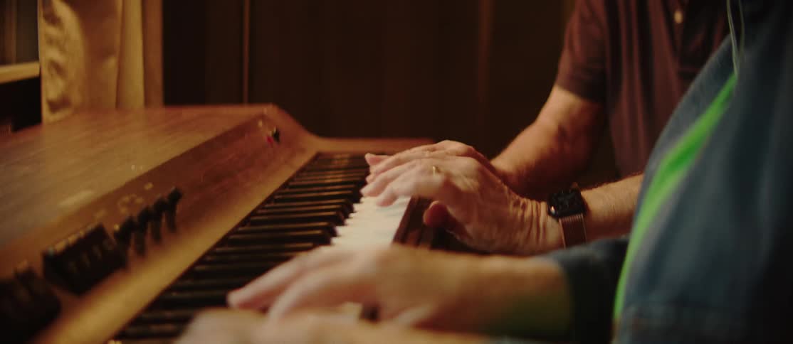 Happy elderly couple playing the piano