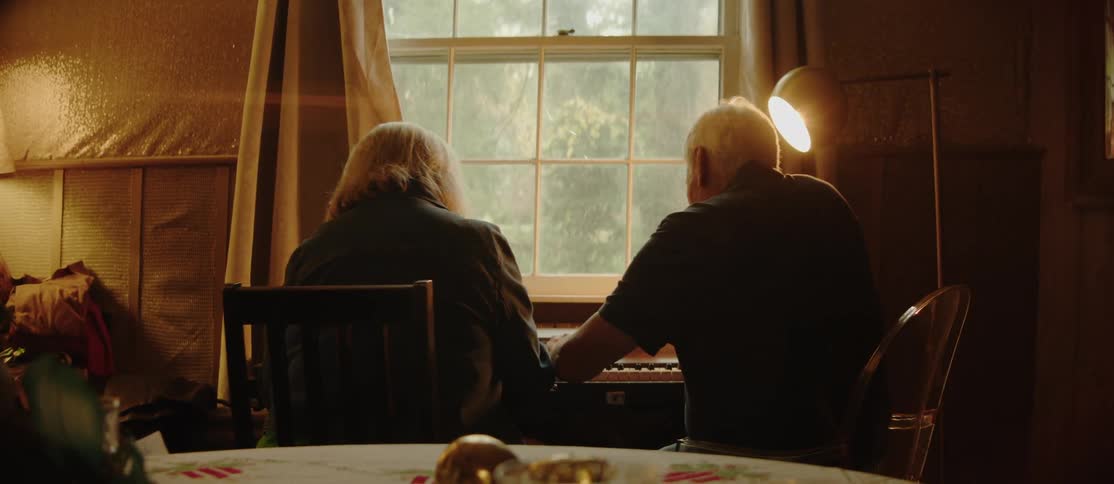 Couple sitting together playing piano