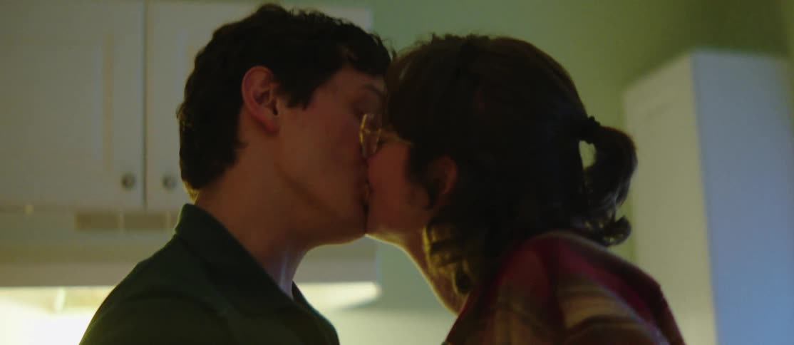 Couple in an indoor space kissing