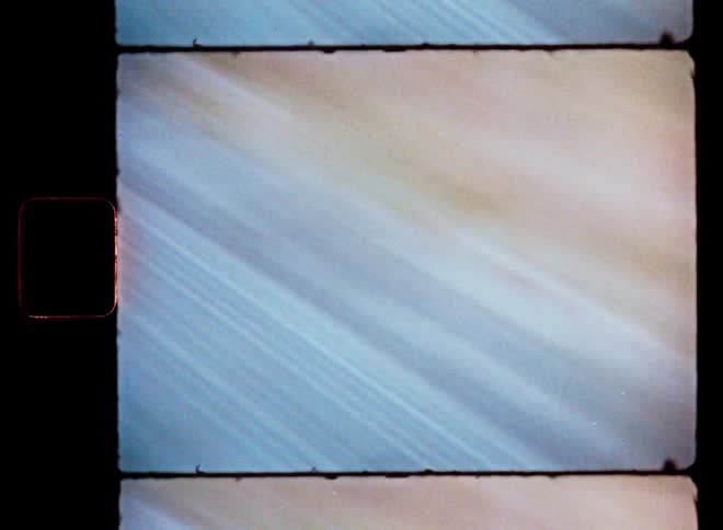 A blurred vintage film shows a road seen from a moving car