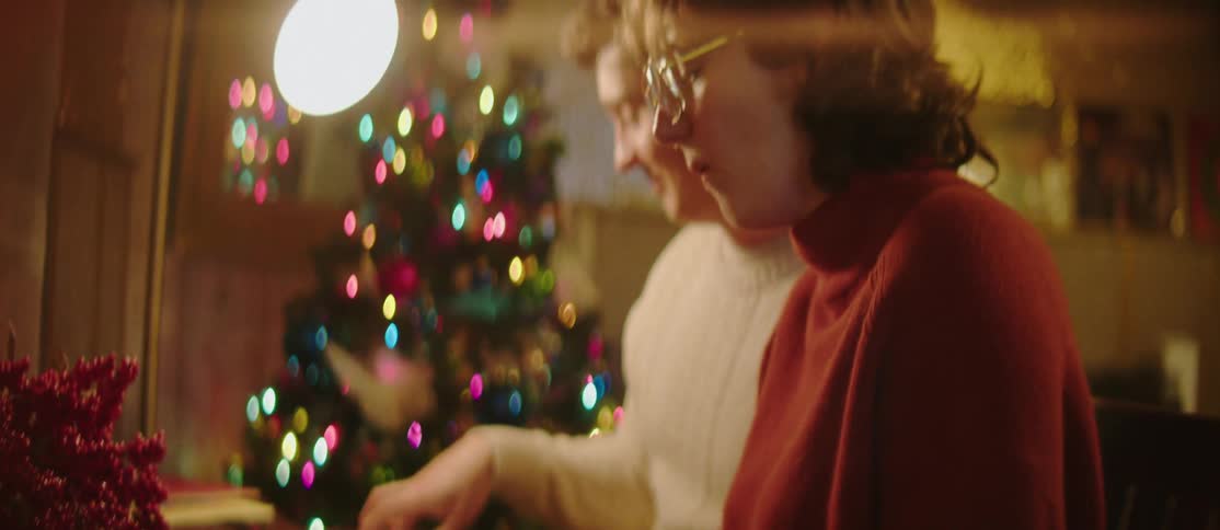 Couple sitting in front of a piano and playing
