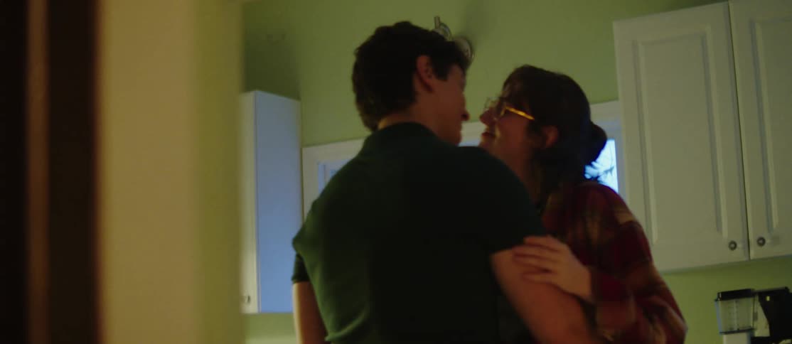 A young couple dancing in the kitchen at home