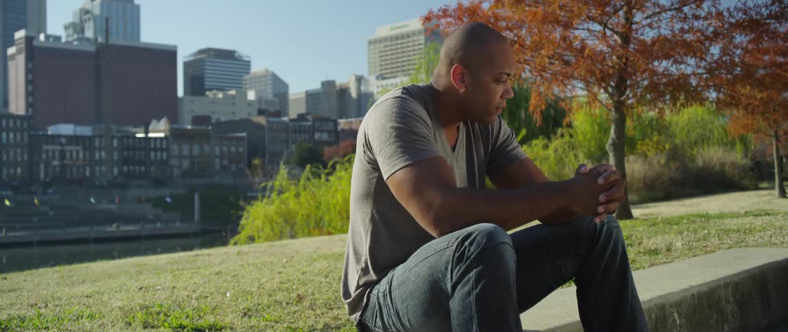 A man sits in a city park