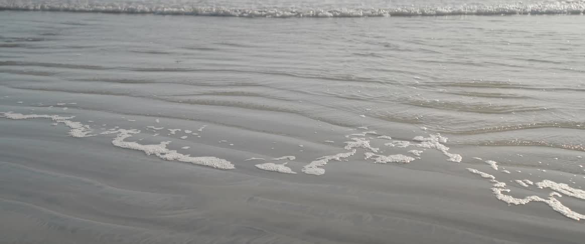 Sea water reaching the beach sand