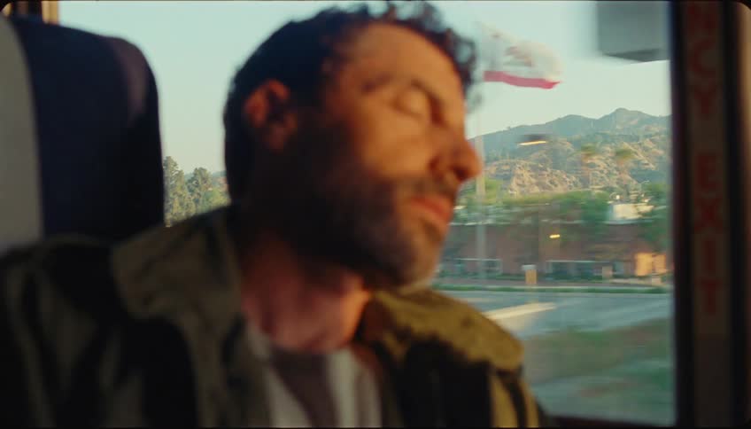 Man sleeping inside a moving bus