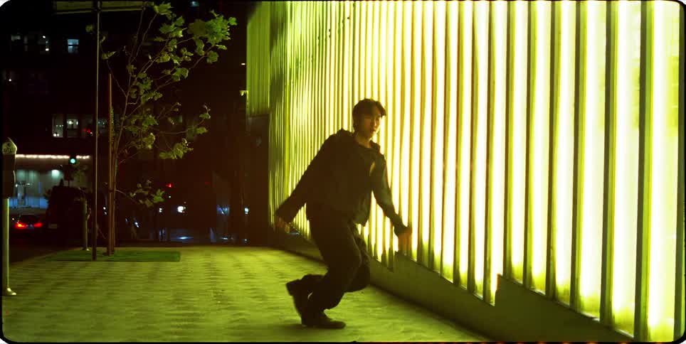 A man is dancing by the lights on the wall