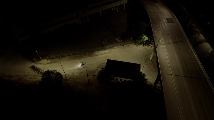 An aerial clip of a moving bike in the night