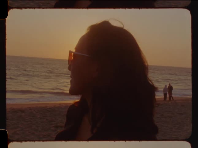 Side portrait of a woman on the beach at sunset