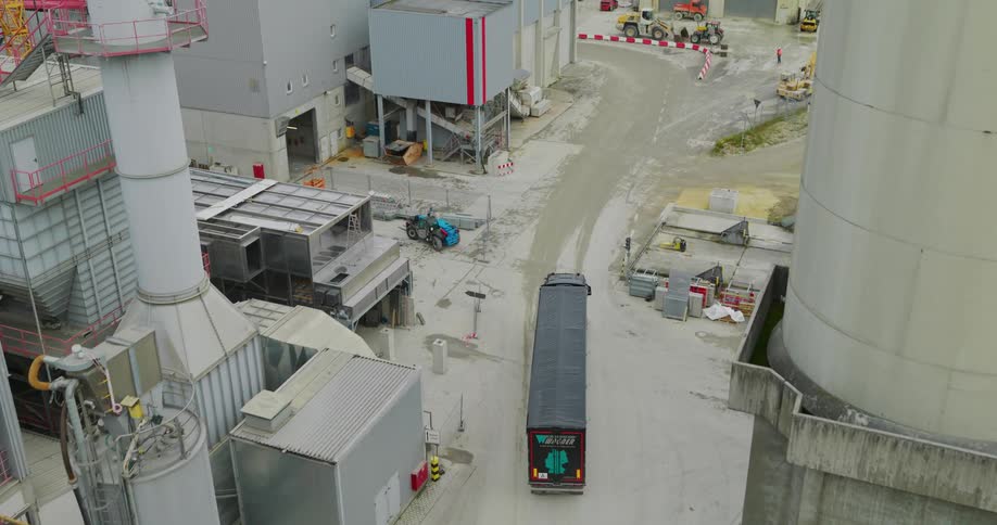 Aerial view of a cargo truck traveling through a logistics center