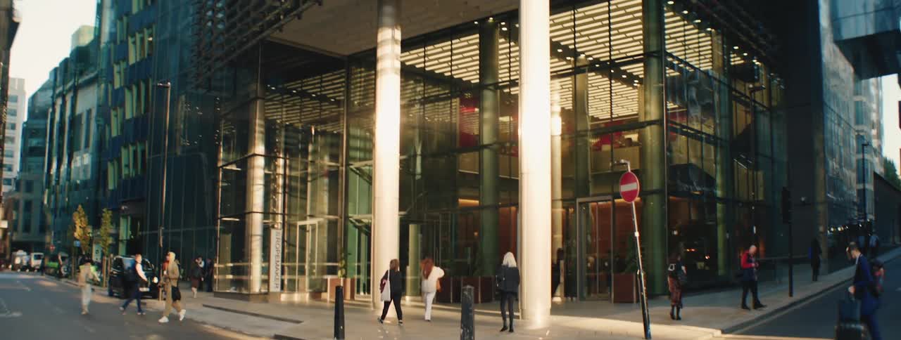Street in a metropolis with pedestrians next to modern buildings