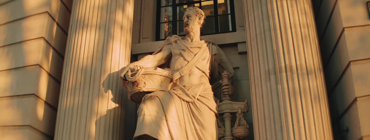 Ancient statue between columns in a classical building