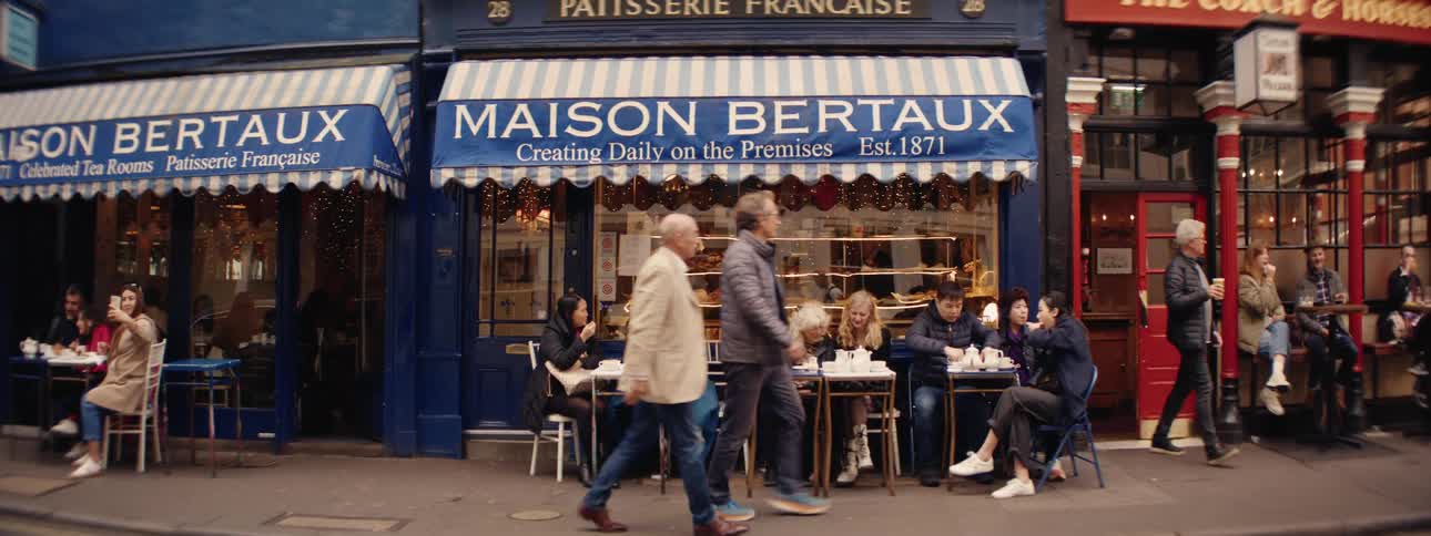 Customers enter and exit a cafe with external seating
