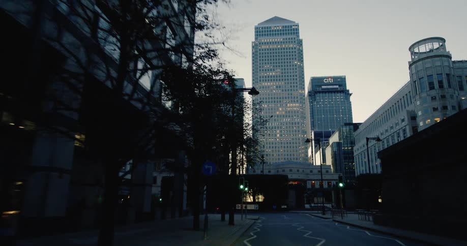A tall building is at the end of the road