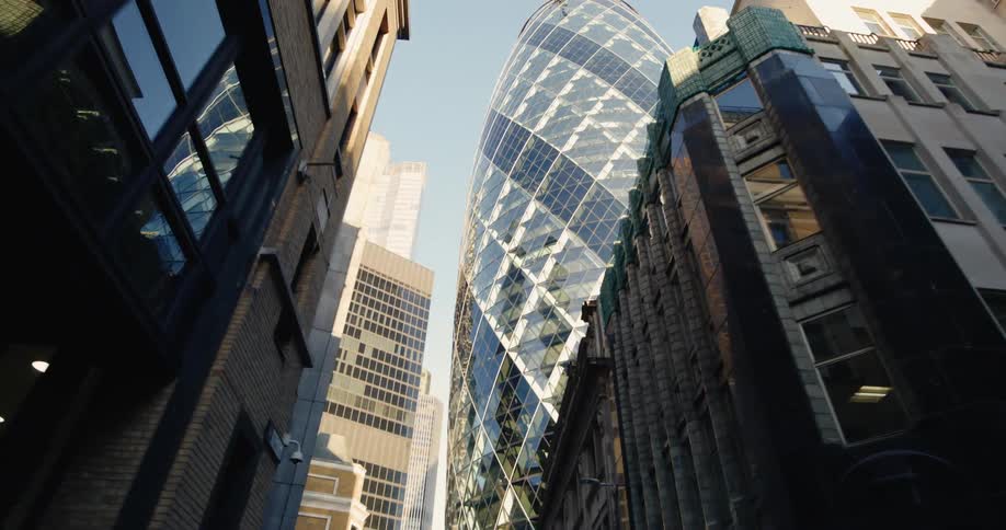 A tall circular building is in the city