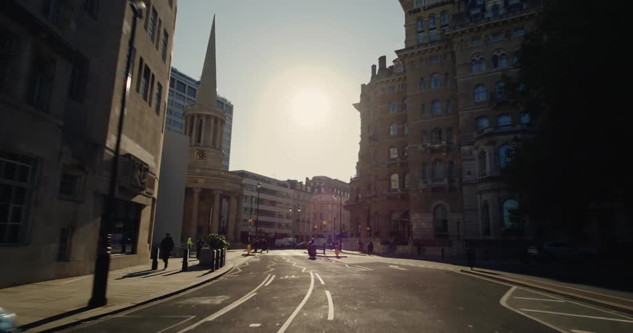 Street in a busy metropolis with vehicle and pedestrian traffic and classic buildings