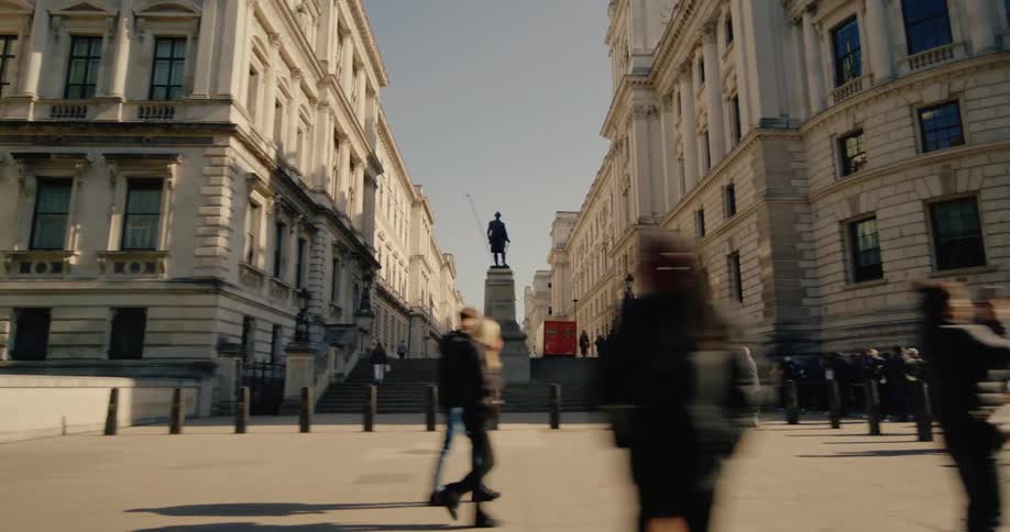 Streets of a metropolis with a square and classic buildings and a crowd of pedestrians walking by