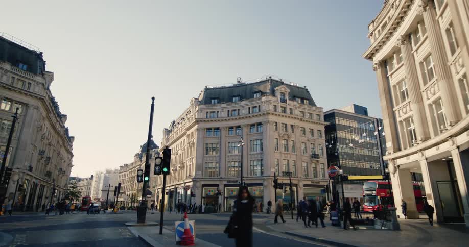 Urban street with classic buildings with vehicle and pedestrian traffic