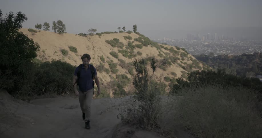A man hikes up a mountain trail
