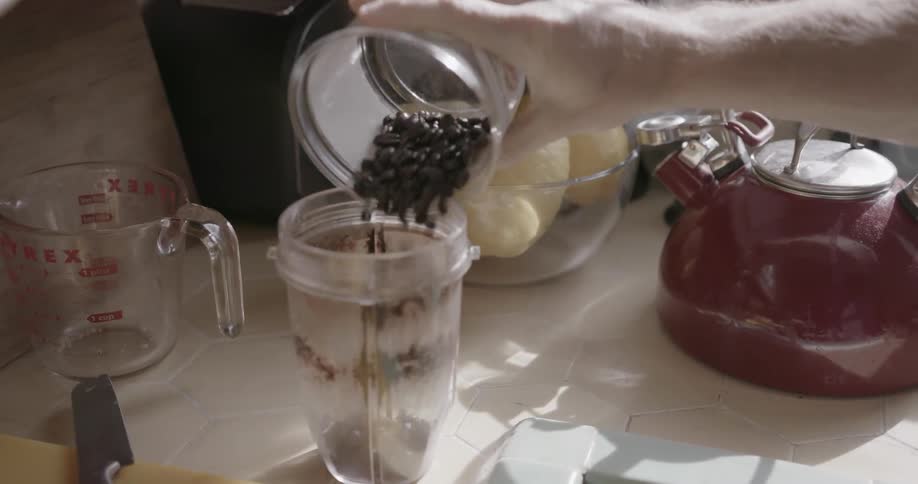 Coffee beans are poured into a container