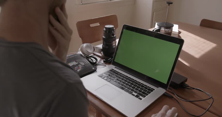 A guy is doing work on his laptop computer