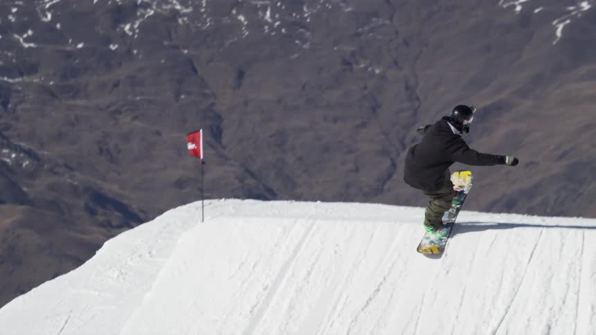 A man performing a snowboarding trick