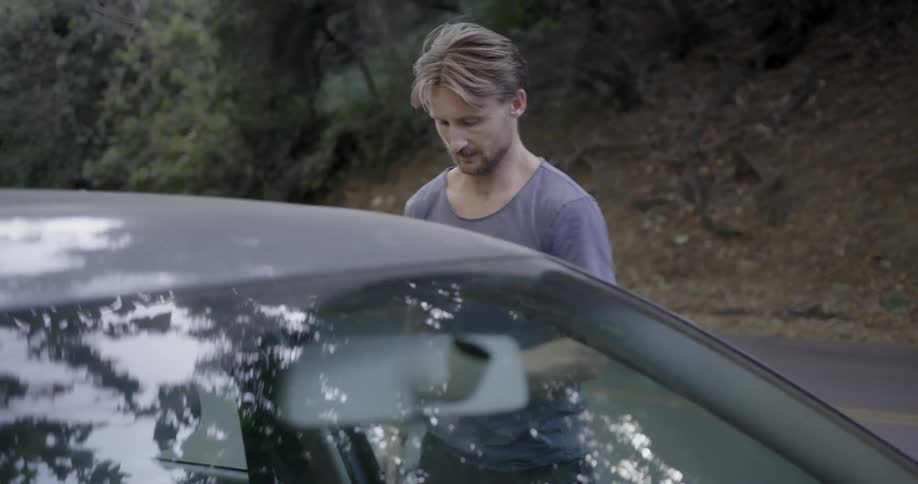 A man gets out of a car