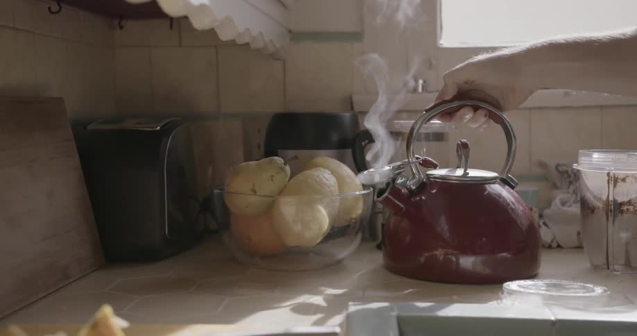 A steaming kettle is placed on a countertop