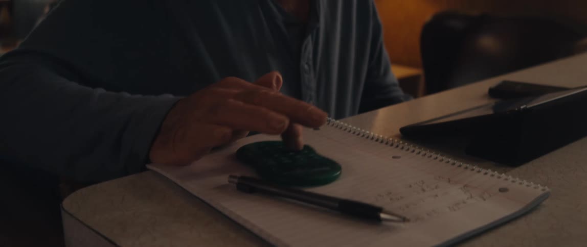 Elderly man typing on a calculator