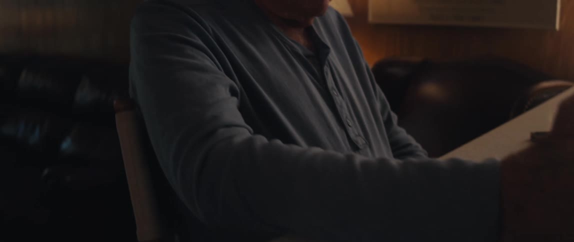 Elderly man sitting in front of a tablet