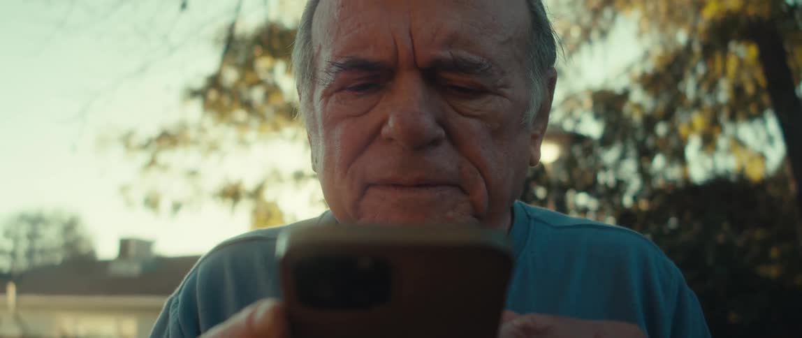 Elderly man interacting with a smartphone