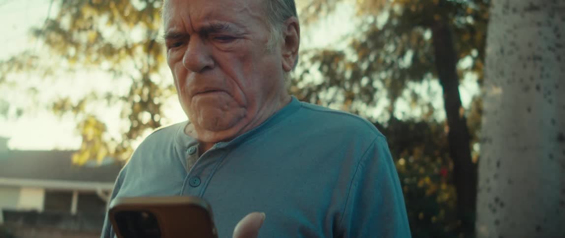 Elderly man outdoors using a smartphone