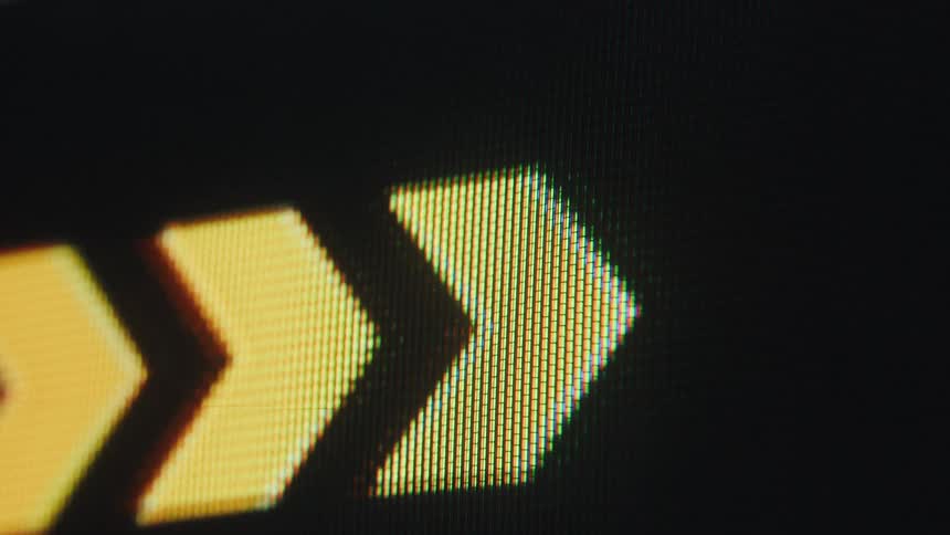 Close up of a screen displaying abstract arrows