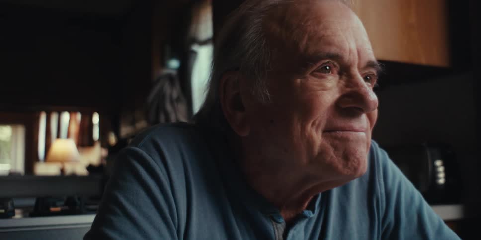 Elderly man sitting happily