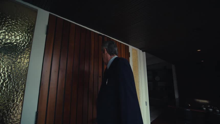 Man in suit entering the house