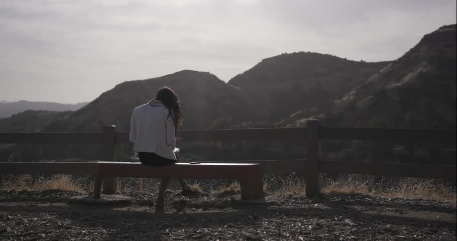 A woman is sitting on a bench