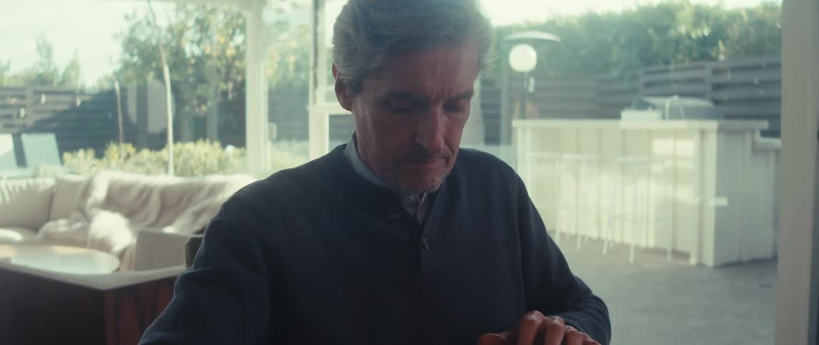 Man sitting at a table making a package