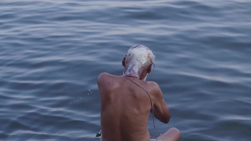 Elderly man bathing in the sea