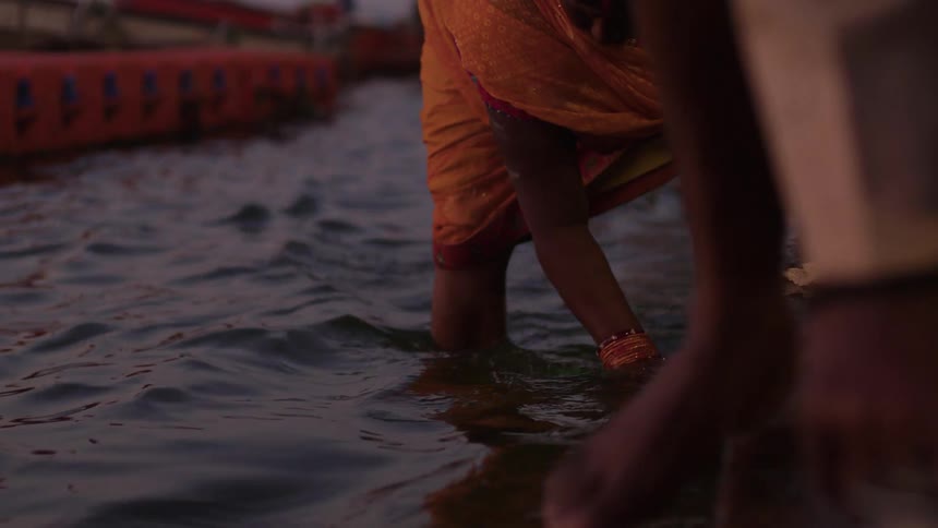 Woman washing clothes in the river