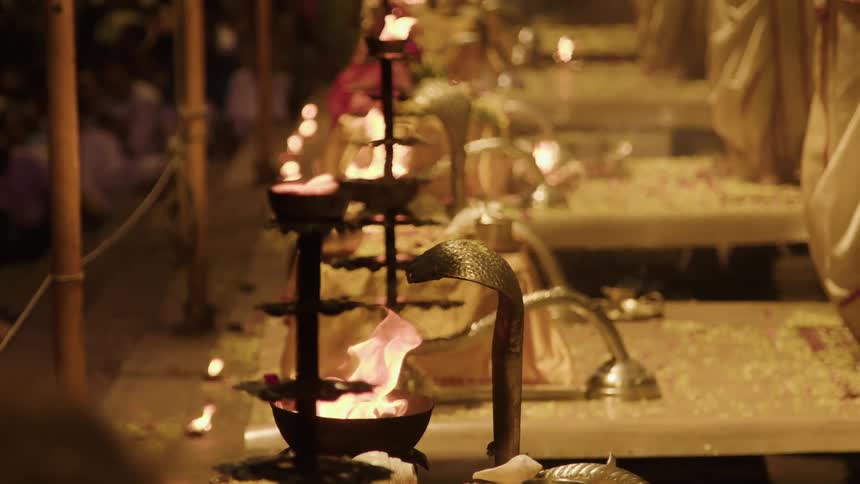 People watching with mouths of fire in a ritual