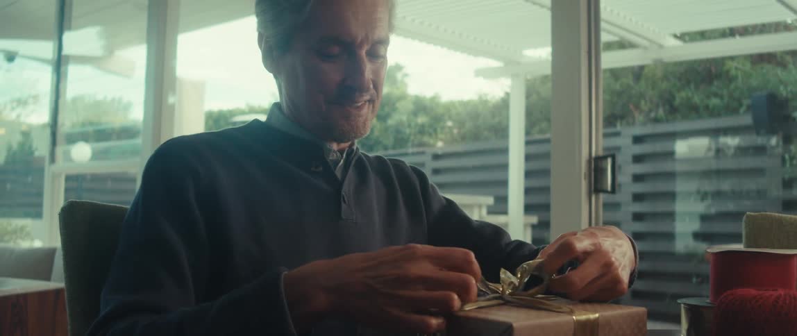Man finishing wrapping a gift