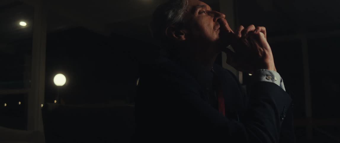 Man sitting with his hand on his face and thinking