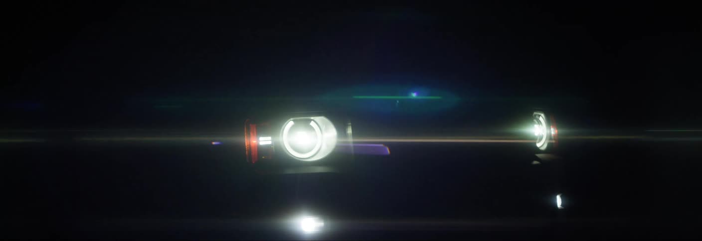 Car headlights head toward the camera