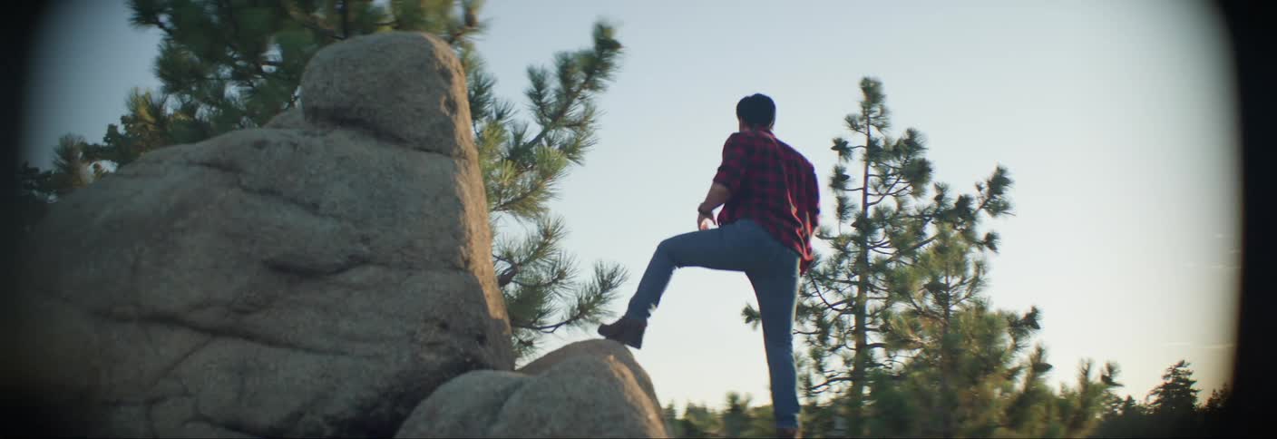 Man climbing large rocks in a natural environment