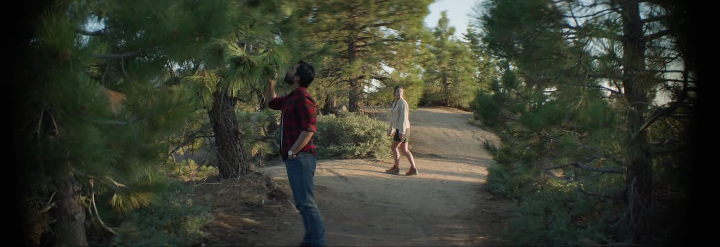 Man and woman on a trail surrounded by trees