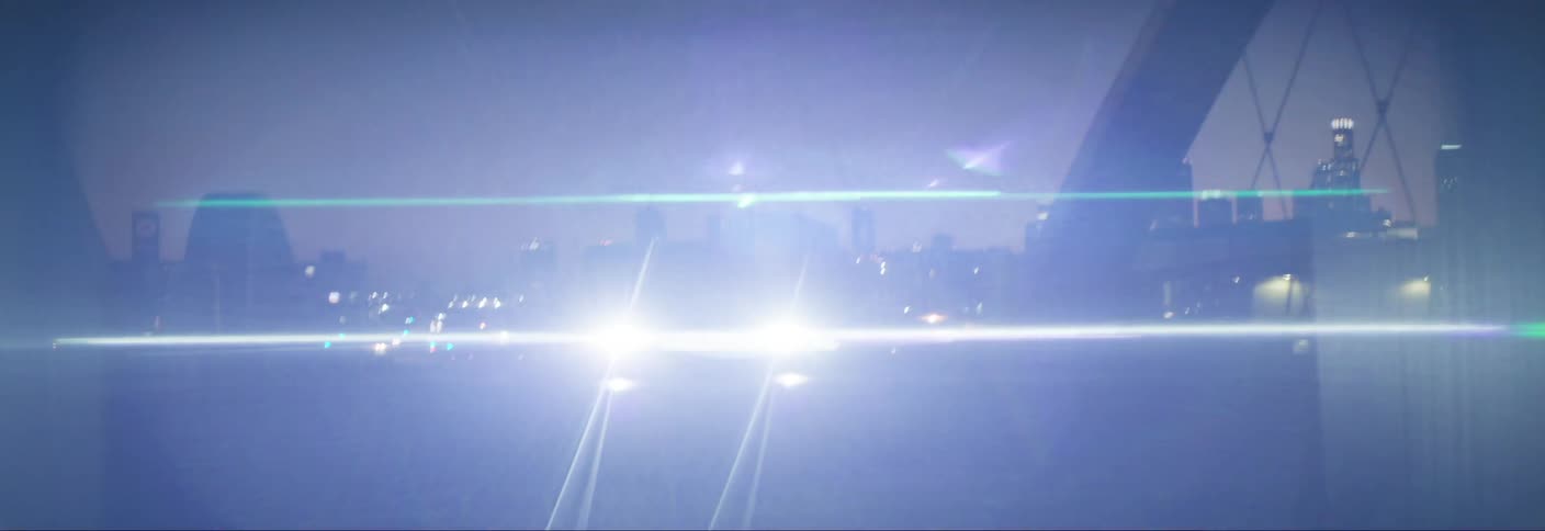 Car crossing a bridge with headlights on through a metropolis at night